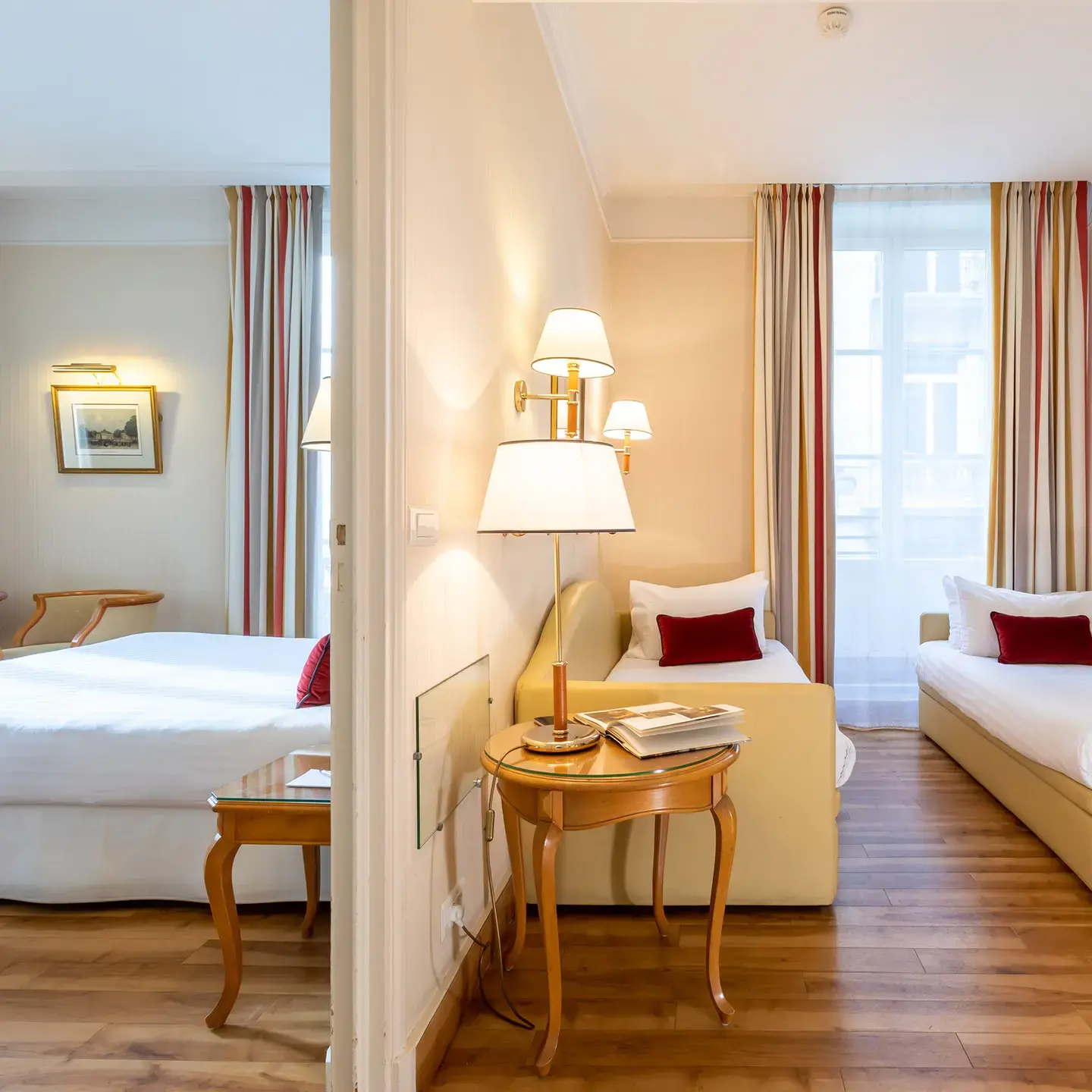 Connected living and sleeping areas in a suite at Hôtel États-Unis Opéra Paris